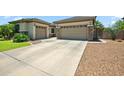 This home features a large driveway with a three-car garage for plenty of parking and easy access at 8417 W Northview Ave, Glendale, AZ 85305