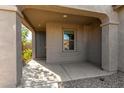 Cozy covered front porch entrance to the home with tiled flooring and neutral paint at 865 E Del Rio St, Chandler, AZ 85225