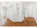 Spacious foyer featuring beautiful wood floors, modern lighting, and a welcoming entrance at 8758 W Myrtle Ave, Glendale, AZ 85305