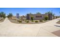 Inviting entrance to The Villages at Accomazzo with lush landscaping and clear signage at 9737 W Agora Ln, Tolleson, AZ 85353