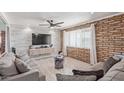 Comfortable living room with a brick wall, plank-style wall, and ceiling fan at 1235 E Dover St, Mesa, AZ 85203