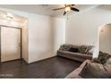 Inviting living room featuring dark hardwood floors, neutral walls, and lots of natural light at 12410 W Flores Dr, El Mirage, AZ 85335