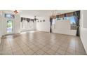 Spacious living room with tile flooring, decorative windows, and neutral color scheme at 15101 W Waterford Dr, Surprise, AZ 85374