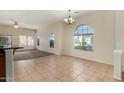 Open floor plan with tile floors, arched window and neutral paint tones create a relaxing ambiance at 16846 N 49Th Way, Scottsdale, AZ 85254