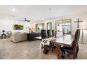 Open-concept living space with a large dining table and comfortable seating area at 17140 W Running Deer Trl, Surprise, AZ 85387