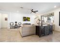 Cozy living room with neutral tones, a mounted TV, and stylish decor at 17140 W Running Deer Trl, Surprise, AZ 85387