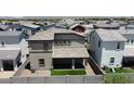 A tan two-story house with a small yard and fence in the back at 1879 W 23Rd Ave, Apache Junction, AZ 85120