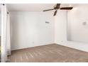 Bright, neutral bedroom with a ceiling fan and carpet flooring at 18805 N 49Th Dr, Glendale, AZ 85308
