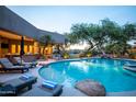 Backyard pool featuring a spa, lounge chairs, and well-maintained landscaping at 22020 N Church Rd, Scottsdale, AZ 85255
