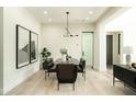 Modern dining room with stylish table and chairs, designer lighting and contemporary artwork at 2315 E Mine Creek Rd, Phoenix, AZ 85024
