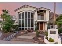 Elegant two-story home features a beautiful front yard, desert landscaping, and stylish architectural details at 2326 E Gardenia Dr, Phoenix, AZ 85020