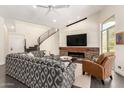 Stylish living room with a fireplace, comfortable seating, and a staircase, creating a cozy and inviting atmosphere at 2326 E Gardenia Dr, Phoenix, AZ 85020