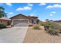 Single-Gathering home featuring a desert landscape, attached two-car garage, and neutral stucco exterior at 24886 W Huntington Dr, Buckeye, AZ 85326