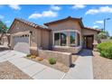 Charming single-Gathering home with a stucco exterior, tiled roof, and well-maintained desert landscaping at 24886 W Huntington Dr, Buckeye, AZ 85326