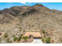 Expansive aerial view of a desert home, showcasing the tile roof and proximity to the mountain at 2722 W Hiddenview Dr, Phoenix, AZ 85045