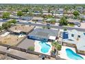 An aerial view showcases a private backyard, mature landscaping, and a refreshing swimming pool at 310 E Fremont Dr, Tempe, AZ 85282