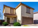 Inviting two-story home featuring a two-car garage and well-manicured landscaping at 3235 S Bowman Rd, Apache Junction, AZ 85119