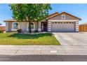 Charming home exterior with a well-manicured lawn, mature tree, and a two-car garage at 3619 E Thornton Ave, Gilbert, AZ 85297