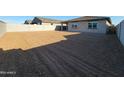 Large, leveled backyard ready for landscaping and outdoor activities, enclosed by a sturdy block wall at 37427 W San Sisto Ave, Maricopa, AZ 85138