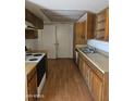 Kitchen featuring laminate wood floors, cabinets, and ample countertop space at 3807 W Mitchell Dr, Phoenix, AZ 85019