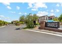 Well maintained gated community entrance with mature landscaping and signage at 3900 E Baseline Rd # 166, Phoenix, AZ 85042