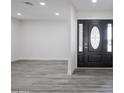 Elegant entryway with modern gray floors and a stunning front door at 4116 W Marshall Ave, Phoenix, AZ 85019