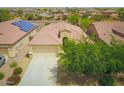Aerial view of a single Gathering home with a well manicured desert landscape, tile roof, and spacious driveway at 41162 W Hayden Dr, Maricopa, AZ 85138