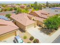 Aerial view of a single Gathering home with a desert landscape, tile roof, and a spacious driveway at 41162 W Hayden Dr, Maricopa, AZ 85138