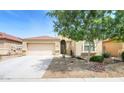 Beautiful single Gathering home featuring desert landscaping, a two car garage, and a warm color scheme at 41162 W Hayden Dr, Maricopa, AZ 85138
