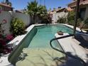 Backyard with a sparkling pool surrounded by lush landscaping providing a private oasis at 4301 E Amberwood Dr, Phoenix, AZ 85048