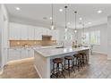 Spacious kitchen with breakfast bar, stainless steel appliances, and designer lighting at 4426 E Leroy St, Gilbert, AZ 85295