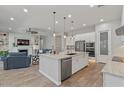 Modern kitchen with stainless appliances, granite counters, pendant lighting, and open floorplan at 4426 E Leroy St, Gilbert, AZ 85295