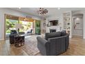 Comfortable living room with fireplace, built in shelving, ceiling fan, and access to patio at 4426 E Leroy St, Gilbert, AZ 85295