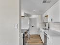 Modern kitchen featuring white cabinets, stainless steel appliances, and sleek countertops at 4714 E Broadway Rd, Phoenix, AZ 85040