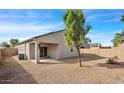 Private backyard with low maintenance landscape, a covered patio, and mature landscaping at 6999 S Blue Hills Dr, Buckeye, AZ 85326