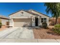Charming single-story home with low maintenance landscape, a two-car garage, and covered entry way at 6999 S Blue Hills Dr, Buckeye, AZ 85326