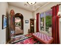 Inviting foyer with decorative rug, bench seating, and an arched doorway leading to an outdoor view at 8139 E Club Village Dr, Gold Canyon, AZ 85118
