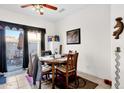 Cozy dining area with a ceiling fan, sliding door to the patio, and wooden table set at 8429 W Vernon Ave, Phoenix, AZ 85037
