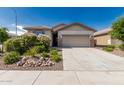 Inviting single-Gathering home with a spacious driveway, two-car garage and beautiful desert landscaping at 9822 W Caron Dr, Peoria, AZ 85345