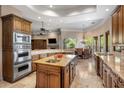 Gourmet kitchen with custom cabinets, stainless steel appliances, and an oversized center island at 10511 E Skinner Dr, Scottsdale, AZ 85262