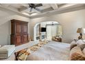 Relaxing main bedroom featuring a fireplace, sitting area, ceiling fan, and neutral colors at 10511 E Skinner Dr, Scottsdale, AZ 85262