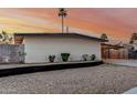 Single-story home features desert landscaping, painted in neutral colors, and a convenient covered parking area at 1258 E Campus Dr, Tempe, AZ 85282