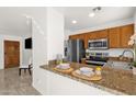 Modern kitchen featuring granite countertops, stainless steel appliances, and a breakfast bar at 13636 N Saguaro Blvd # 103, Fountain Hills, AZ 85268