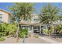 Inviting two-story home featuring a cozy front porch swing, lush landscaping, and a charming exterior at 1482 S Banning St, Gilbert, AZ 85296