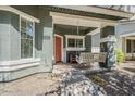 Welcoming front porch with a cozy swing, ample seating, and charming decorative touches at 1482 S Banning St, Gilbert, AZ 85296