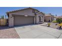 Single-story home featuring a two-car garage and low-maintenance desert landscaping at 15905 W Saguaro Ln, Surprise, AZ 85374