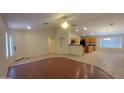 The spacious open concept living room features hard floors that seamlessly connects to the dining and kitchen areas at 15905 W Saguaro Ln, Surprise, AZ 85374