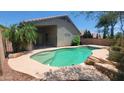 A beautiful private pool is surrounded by lush landscaping, perfect for outdoor relaxation and entertainment at 15905 W Saguaro Ln, Surprise, AZ 85374