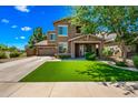 Charming two-story home with a well-manicured lawn and an inviting stone-accented entryway, perfect for Gathering living at 18045 W Rimrock St, Surprise, AZ 85388
