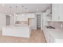 Spacious kitchen boasts custom white cabinetry, quartz countertops, and a walk-in pantry at 20262 W Monterey Way, Buckeye, AZ 85396
